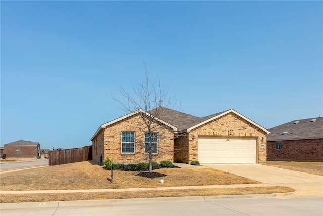 ranch-style home with a garage, fence, concrete driveway, and brick siding