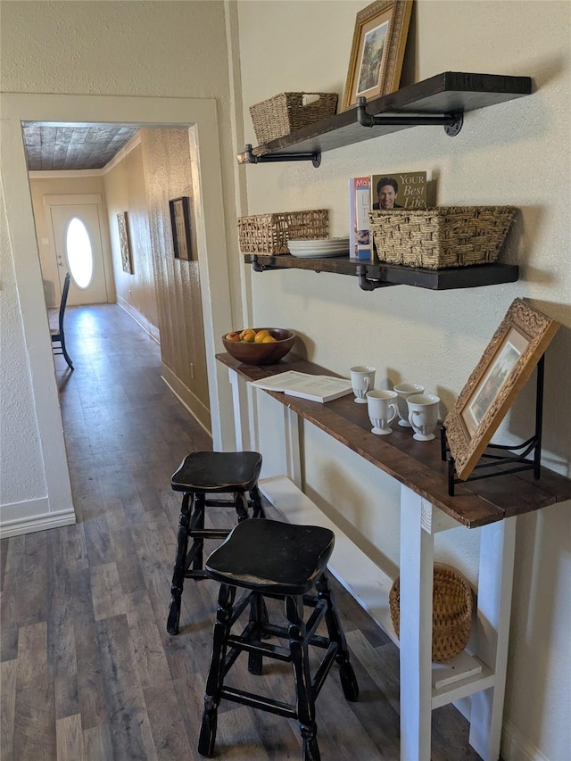 interior space with baseboards and wood finished floors