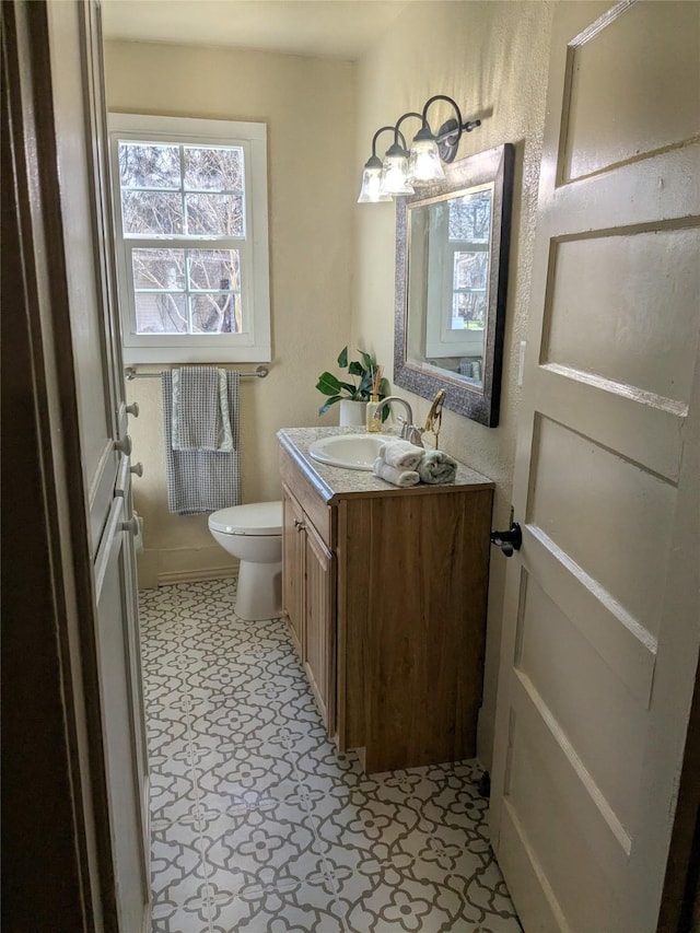 half bath featuring toilet and vanity