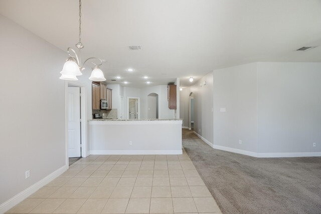 interior space with arched walkways, recessed lighting, visible vents, light tile patterned flooring, and baseboards