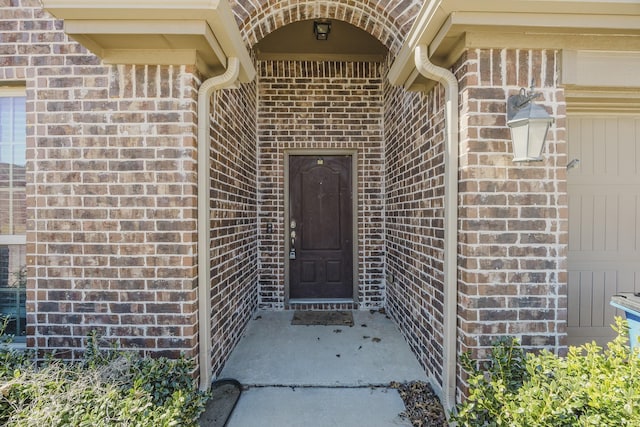 doorway to property with brick siding