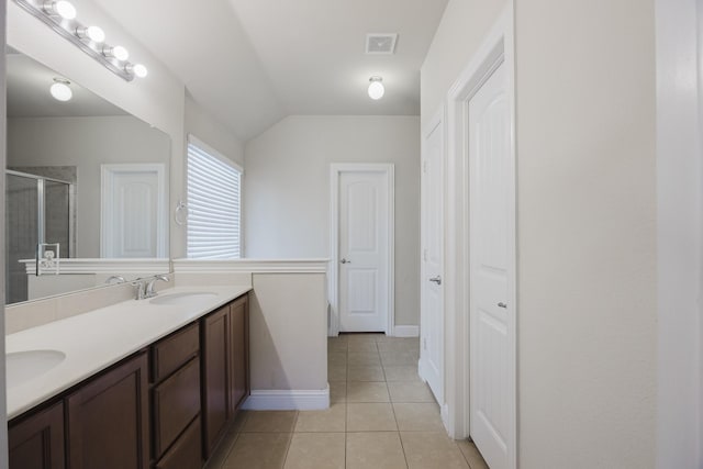 full bathroom featuring double vanity, visible vents, tile patterned floors, a shower stall, and a sink