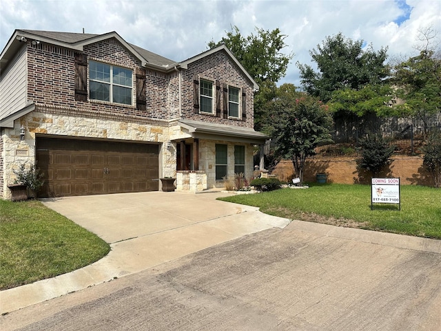 view of front of house with concrete driveway, a front lawn, stone siding, and brick siding