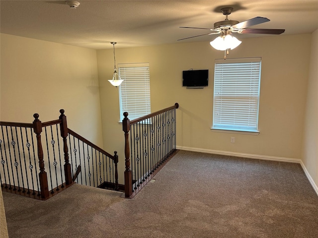 staircase featuring carpet and baseboards