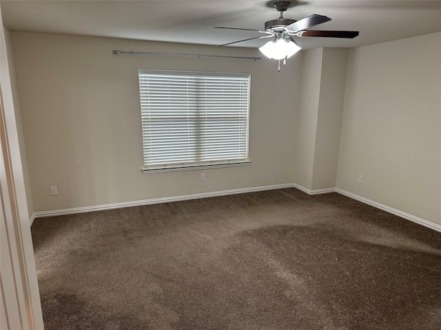 spare room featuring ceiling fan, carpet, and baseboards