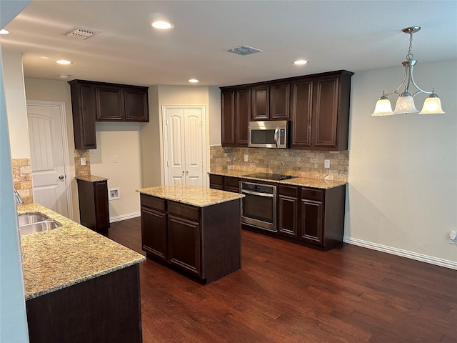 kitchen featuring stainless steel appliances, visible vents, and dark brown cabinets