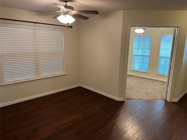 unfurnished room with ceiling fan, dark wood-style flooring, and baseboards