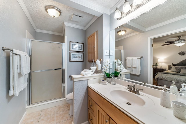 ensuite bathroom with ornamental molding, tile patterned floors, a textured ceiling, vanity, and a shower stall