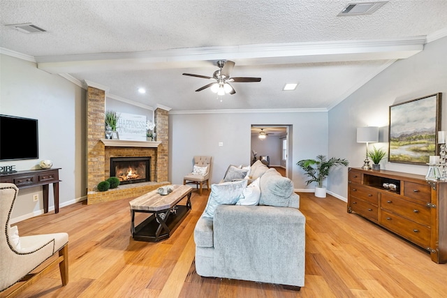 living area with lofted ceiling with beams, visible vents, and a textured ceiling