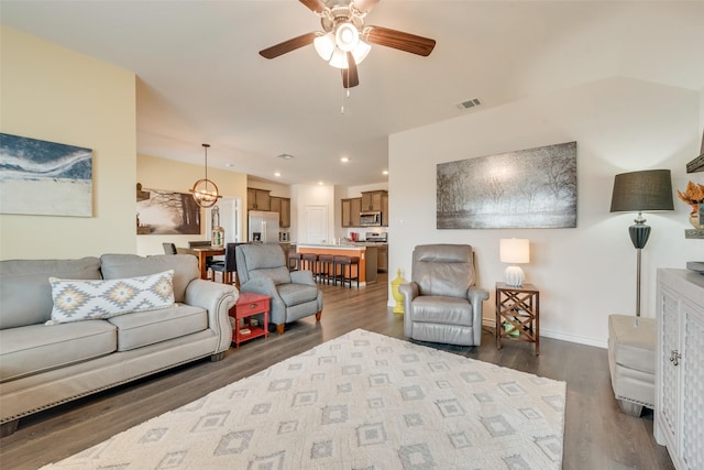 living room with recessed lighting, dark wood-style flooring, a ceiling fan, visible vents, and baseboards