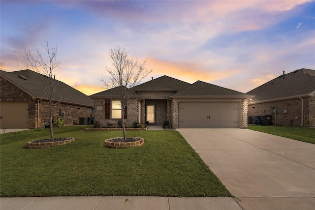 view of front of property featuring an attached garage, brick siding, driveway, roof with shingles, and a front lawn