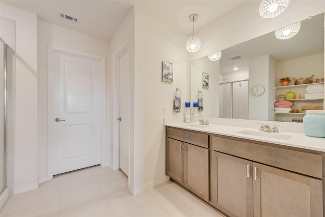 full bath featuring baseboards, double vanity, a sink, and a shower stall