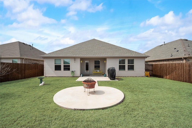 rear view of property featuring an outdoor fire pit, a fenced backyard, and a yard