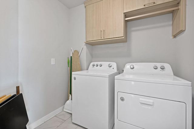 laundry room with marble finish floor, independent washer and dryer, cabinet space, and baseboards