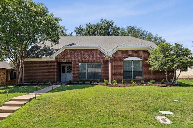 1542 Glenmore Dr, Lewisville, TX 75077 - ranch-style house featuring brick siding, a front yard, and roof with shingles