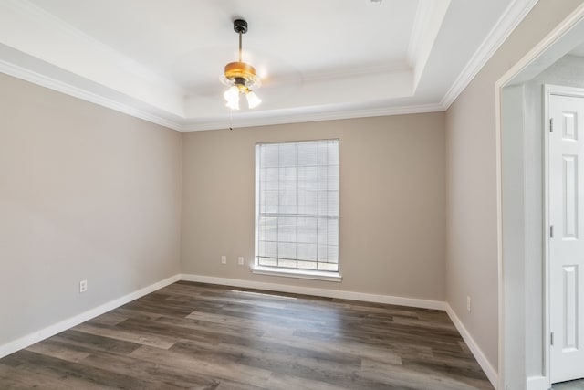 spare room with dark wood finished floors, baseboards, a raised ceiling, and ceiling fan