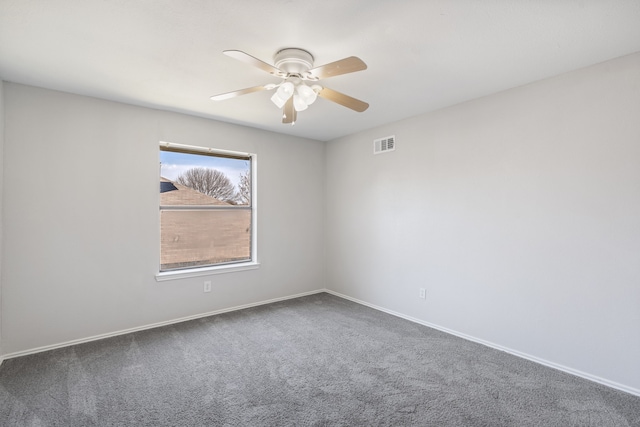 unfurnished room featuring visible vents, carpet flooring, baseboards, and a ceiling fan