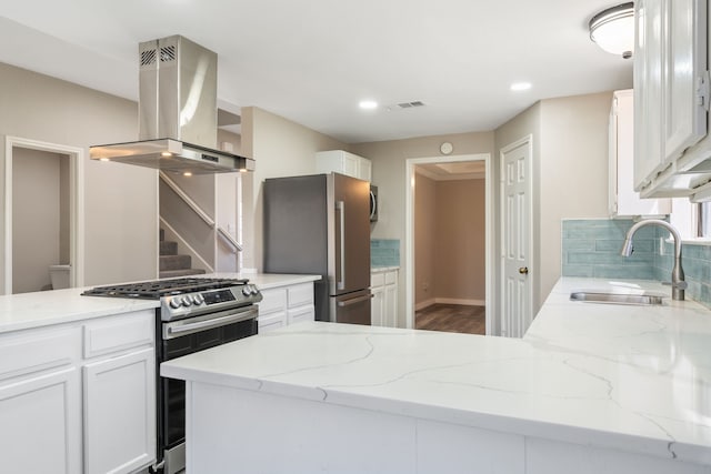 1542 Glenmore Dr, Lewisville, TX 75077 - kitchen with island exhaust hood, a sink, stainless steel appliances, white cabinetry, and light stone countertops