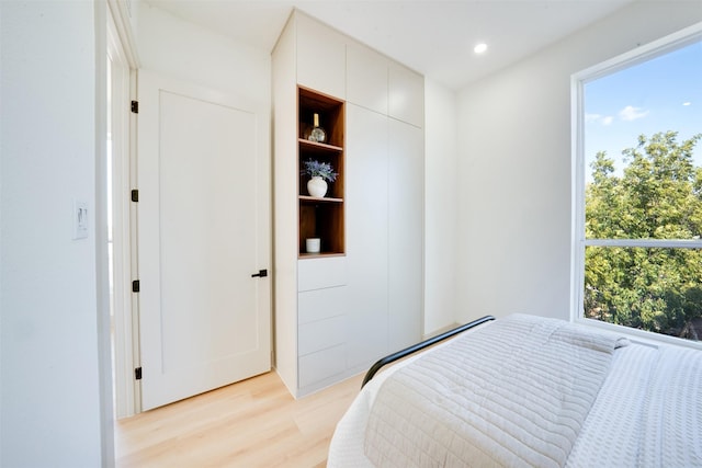 bedroom with recessed lighting, multiple windows, and light wood-style flooring