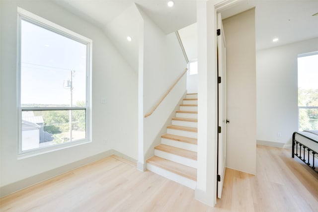 stairway with recessed lighting, baseboards, and wood finished floors