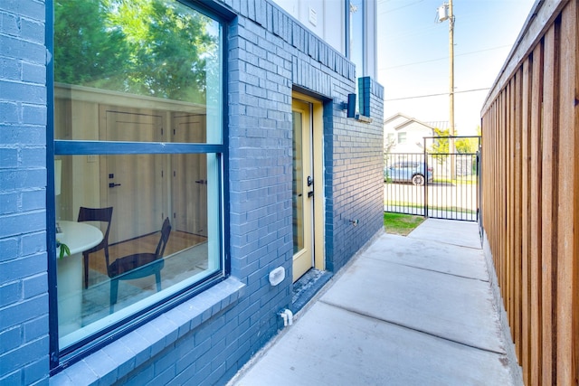 property entrance featuring brick siding