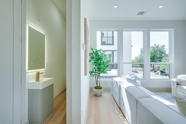 interior space featuring light wood-style floors, baseboards, visible vents, and recessed lighting