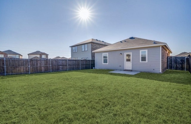 back of property featuring a patio, a lawn, and a fenced backyard