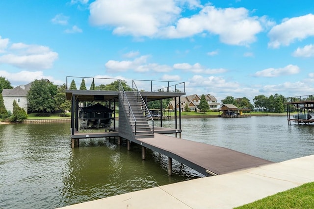 dock area with stairway, a water view, and boat lift