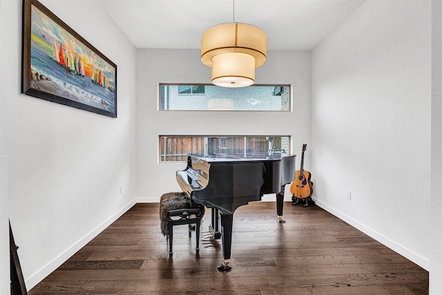 living area with baseboards and wood finished floors