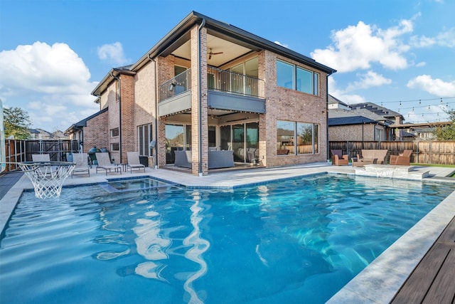 view of pool with a fenced in pool, ceiling fan, outdoor lounge area, a fenced backyard, and a patio area