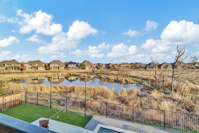 water view featuring a residential view and fence