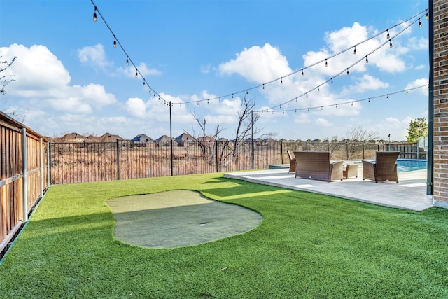 view of yard with a patio area, a fenced in pool, and a fenced backyard