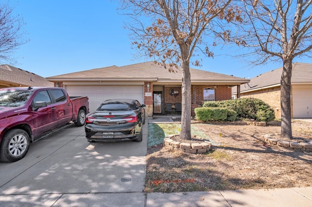 ranch-style home with a garage, concrete driveway, and brick siding