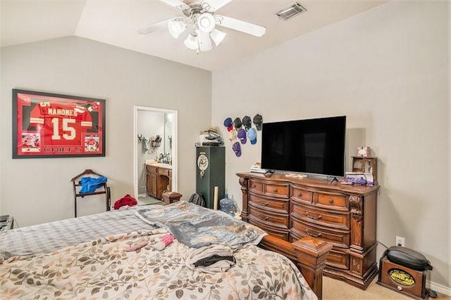 bedroom featuring carpet floors, lofted ceiling, visible vents, ensuite bathroom, and ceiling fan