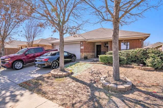 single story home with a garage, brick siding, and driveway