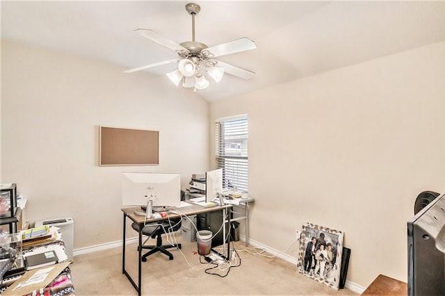 carpeted office space featuring lofted ceiling, ceiling fan, and baseboards