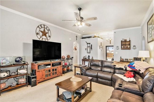 living room with carpet floors, arched walkways, ornamental molding, and ceiling fan with notable chandelier