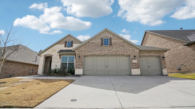 view of front of home featuring driveway, stone siding, roof with shingles, an attached garage, and brick siding