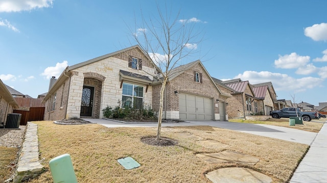 view of front of home featuring fence, an attached garage, concrete driveway, stone siding, and brick siding