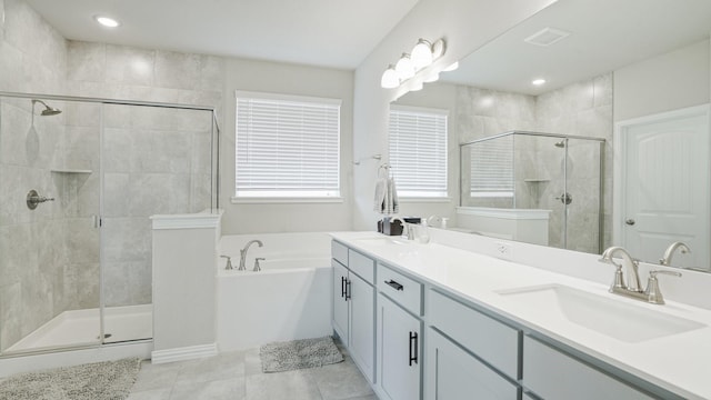 full bathroom featuring tile patterned floors, a stall shower, a sink, double vanity, and a bath