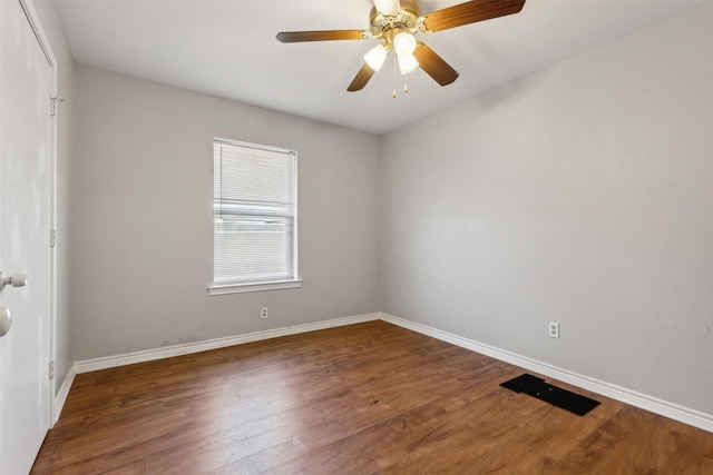 empty room with wood finished floors, baseboards, and ceiling fan