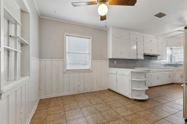 kitchen featuring open shelves, white cabinets, visible vents, and wainscoting