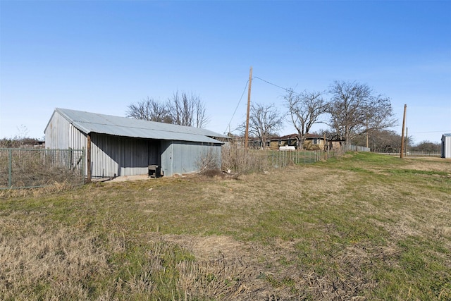 view of yard featuring an outbuilding, fence, and an outdoor structure