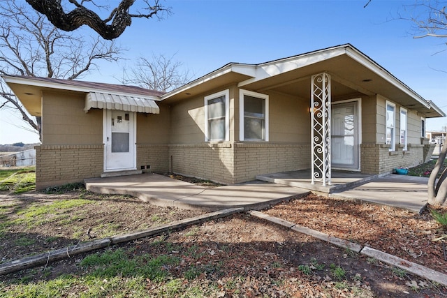 view of front of property with covered porch and brick siding