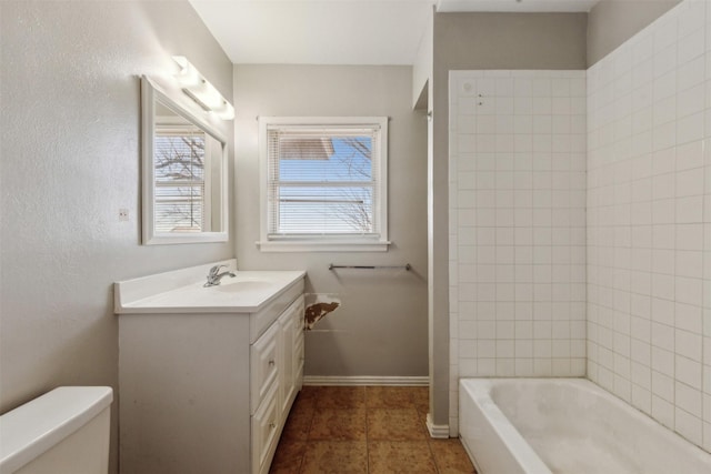 bathroom featuring baseboards, toilet, bathing tub / shower combination, tile patterned floors, and vanity