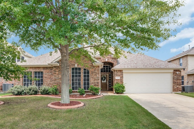 view of front of home with a garage, brick siding, concrete driveway, central air condition unit, and a front yard