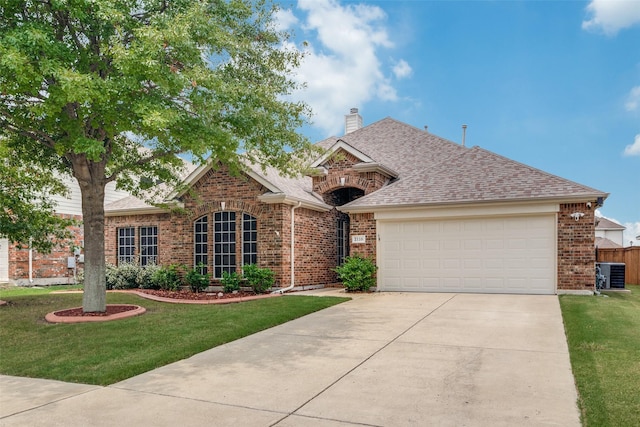 view of front of property with an attached garage, a front lawn, cooling unit, and brick siding