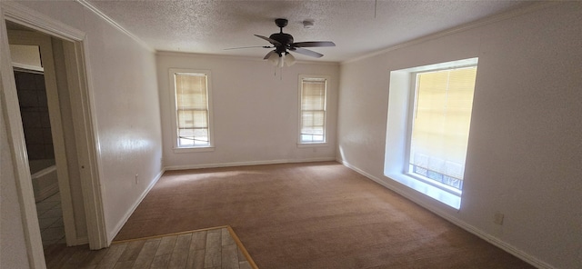 spare room featuring a ceiling fan, a textured ceiling, baseboards, and crown molding