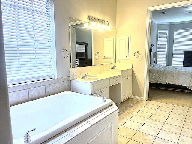 ensuite bathroom featuring tile patterned flooring, a garden tub, ornamental molding, ensuite bath, and a sink