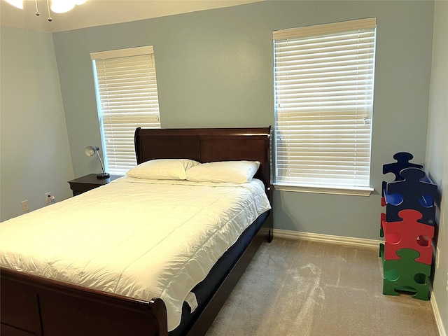 bedroom featuring baseboards and carpet flooring